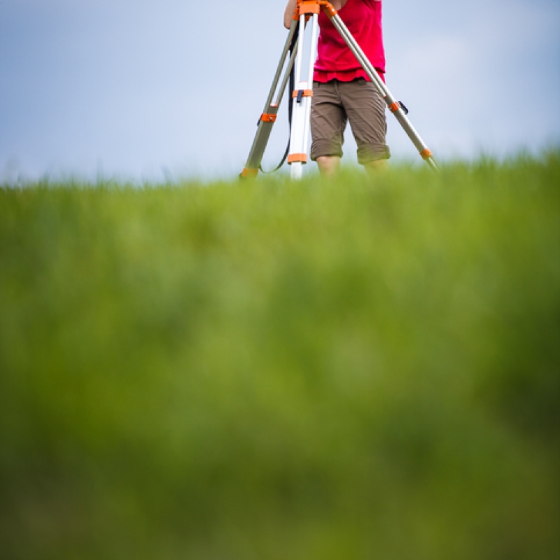 Young, female land surveyor at work