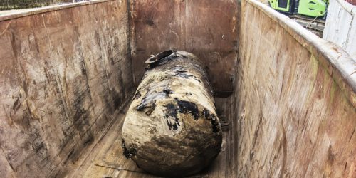 Soil tank excavated during soil remediation is temporarily stored in an iron container for further proper disposal